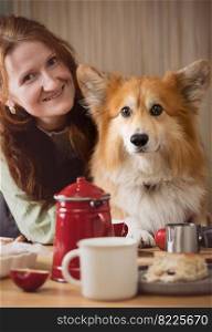 girl and corgi dog posing in the kitchen
