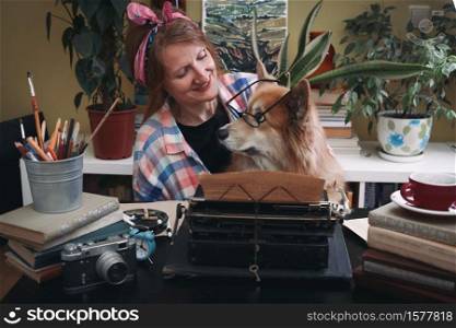 girl and dog corgi typing on a typewriter