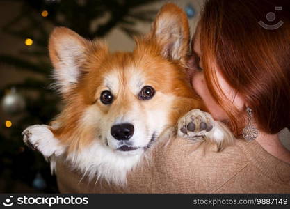 girl and dog embrace one another 