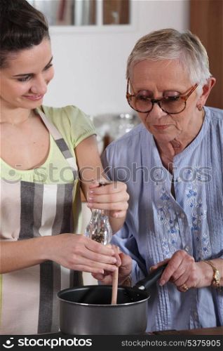 Girl and grandmother cooking