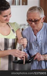 Girl and grandmother cooking