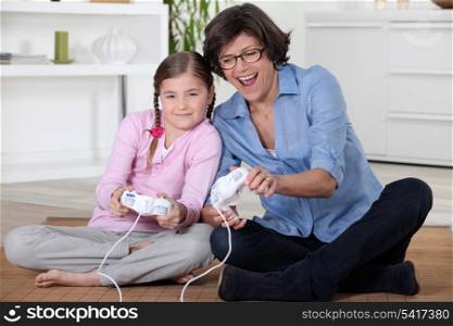 Girl and her grandmother playing computer games