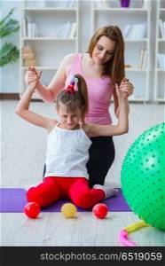 Girl and mother exercising at home