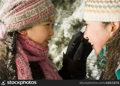 Girl and mother in snow