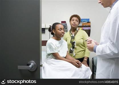Girl and mother listening to doctor