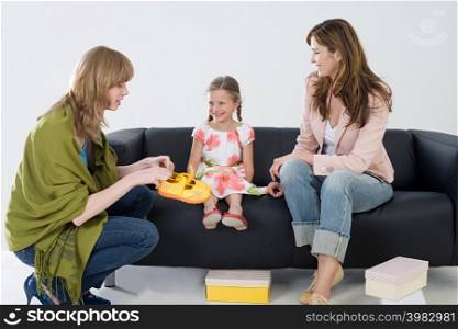 Girl and mother with shoe shop assistant