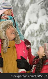 Girl and parents in snow