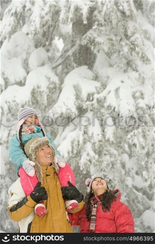 Girl and parents in snow