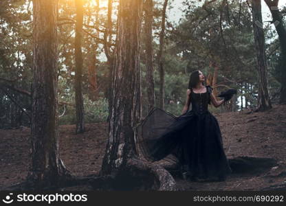 girl and raven in the forest. fabulous themed photo shoot