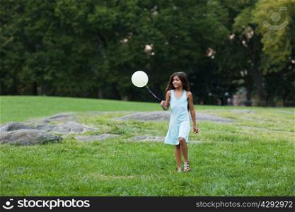 Girl at birthday party holding balloon