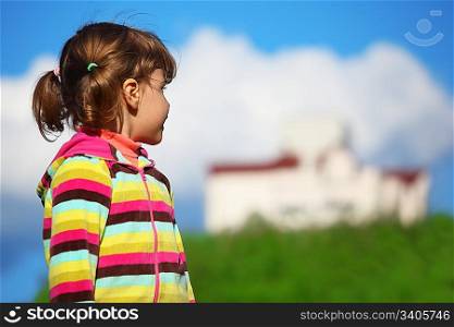 girl at field looking at the home