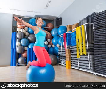 Girl at gym swiss ball knee balance drill exercise workout open arms