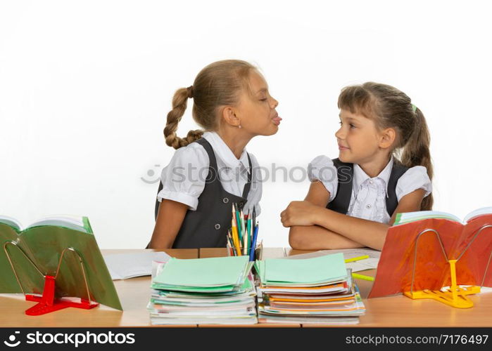Girl at her desk showed tongue to another girl