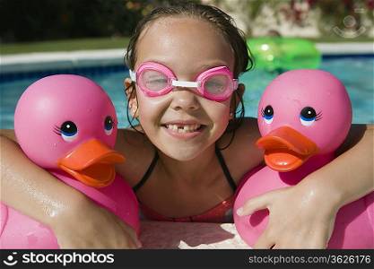 Girl at Pool Side Holding Pink Rubber Ducks