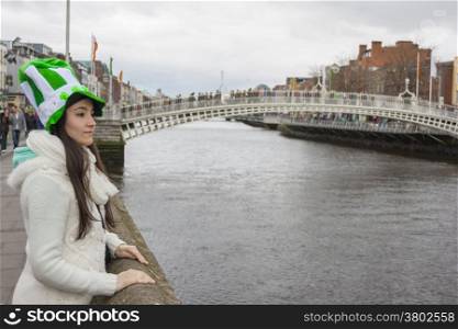 Girl at River liffey close to Hapenny bridge in Dublin