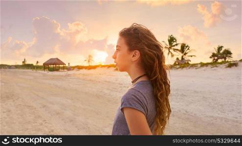 Girl at sunset caribbean beach in Mexico Riviera Maya