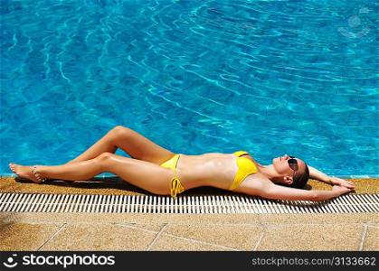 Girl at tropical swimming pool
