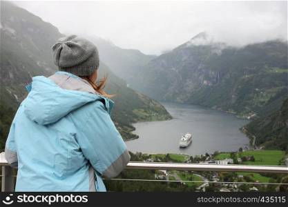 girl at viewpoint looking at the Geiranger fjord