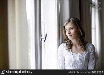 girl at window looking at viewer