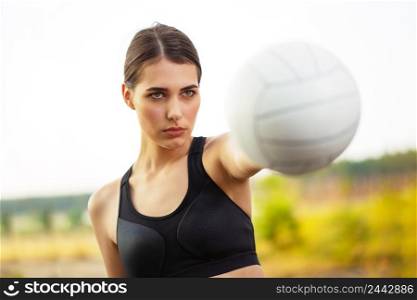 Girl athlete holding a ball in an outstretched hand. Girl athlete holding ball in outstretched hand