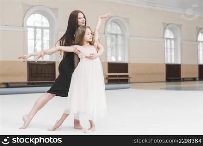 girl ballerina teacher dancing together dance studio