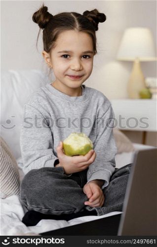 girl bed watching video laptop
