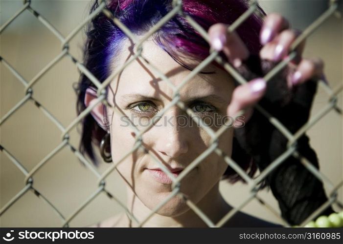 Girl behind a fence