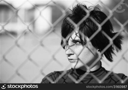 Girl behind a fence