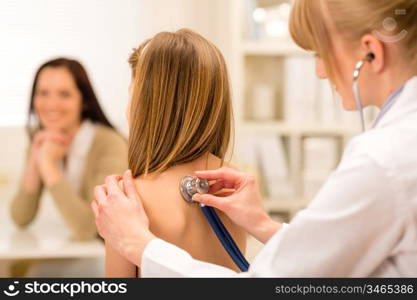 Girl being examine with stethoscope by pediatrician