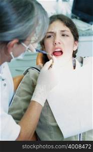 Girl being examined by dentist