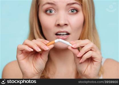 Girl breaking up with cigarette.. Disappointed pretty girl at breaking up with cigarette. Addicted nicotine problems in young age. Quitting from addiction concept by sorrowful.