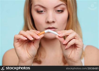 Girl breaking up with cigarette.. Pretty girl breaking up with cigarette. Addicted nicotine problems in young age. Quitting from addiction concept.