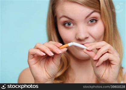 Girl breaking up with cigarette.. Smilling pretty girl breake down cigarette. Winning with addicted nicotine problems in young age. Quitting from addiction concept.