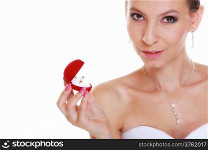 Girl bride in white dress looks at red heart shaped box with engagement or wedding ring, isolated on white background.