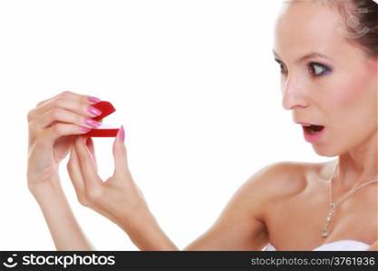 Girl bride in white dress with surprise looks at red box with wedding ring, isolated on white background.