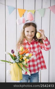 girl bunny ears holding easter egg flowers watering can