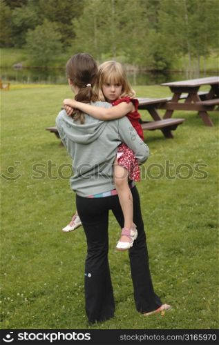 Girl carrying child