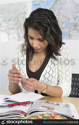 Girl checking the note secretly behind her hand that she just received