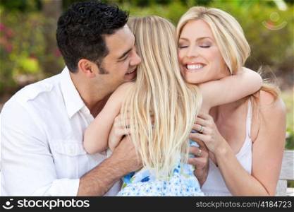 Girl Child Hugging Happy Parents In Park or Garden