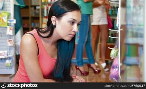 Girl choosing cosmetics in the beauty department
