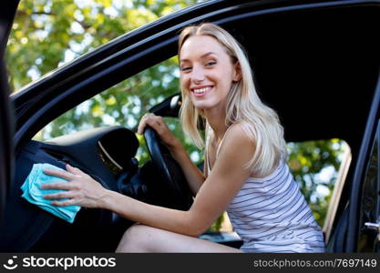 girl cleaning car interior with microfiber