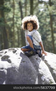 Girl Climbing On Rock In Countryside