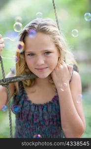 Girl climbing rope ladder with bubbles