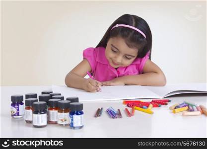 Girl coloring at table against white background