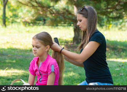 Girl combing hair girl