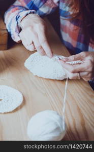 girl crocheting a rug. Woman knits crochet. Home comfort and hobby. Needlework