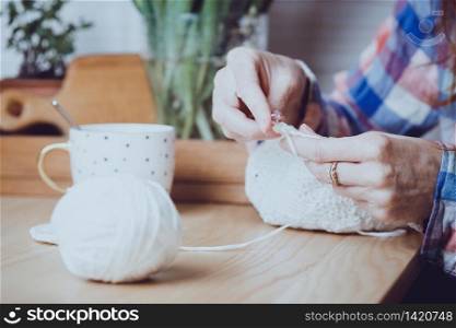 girl crocheting a rug. Woman knits crochet. Home comfort and hobby. Needlework