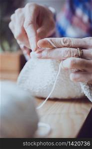 girl crocheting a rug. Woman knits crochet. Home comfort. Needlework