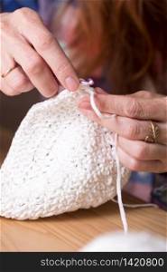 girl crocheting a rug. Woman knits crochet. Home comfort. Needlework