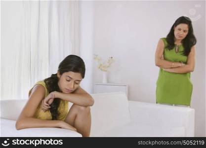 Girl crying while mother looks on